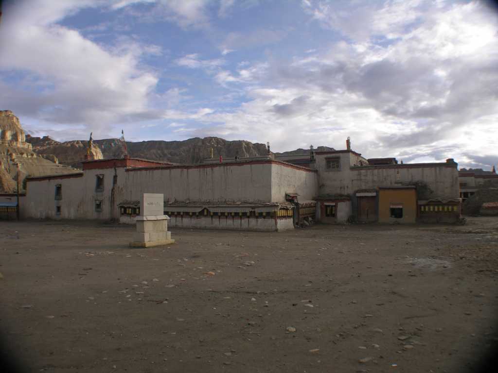 Tibet Guge 03 Tholing 01 Red Temple Buildings In Front Tholing monastery was built in the eleventh century, during the reign of Yeshe-O, the King of Guge, Western Tibet. It proved a refuge for numerous scholars and translators. It was here that Atisha met Lotsawa Rinchen Sangpo and also where he wrote his seminal text, Lamp of the Path, which has remained an inspiration for generations up to the present day. The monastery, said to have been modeled after Samye in Central Tibet, is noted today for the exquisite quality of the murals that cover its walls. These paintings delightfully express the vigour of the transmission of Buddhism from India to Tibet and the dynamic mingling of cultures. Even after so many centuries, which have seen the abandonment and ruin of the buildings that house them, they retain a freshness that is a joy to see.  Dalai Lama, Foreword: Ewald Hein / Gnther Boelmann: Tibet  Der Weie Tempel von Tholing.